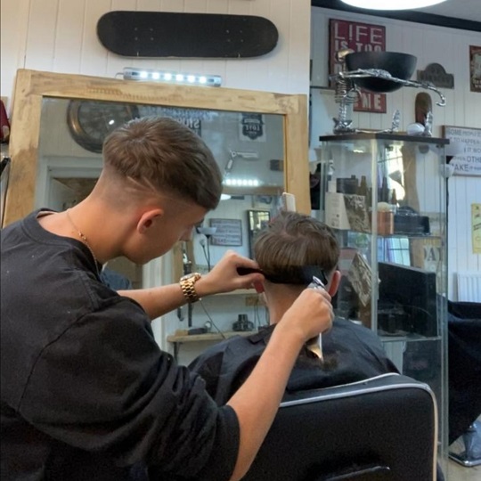 lad cutting hairs
